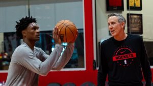 Chip Engelland corrects Amen Thompson's shooting form.