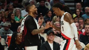Damian Lillard celebrates alongside Ja Morant in his return game with the Blazers.