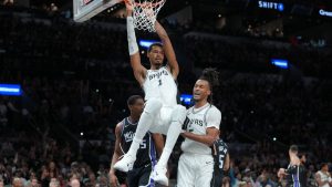 Victor Wembanyama dunks on the Sacramento Kings' rim.