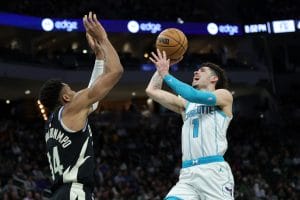 Lamelo Ball tratando de anotar frente a Antetokounmpo